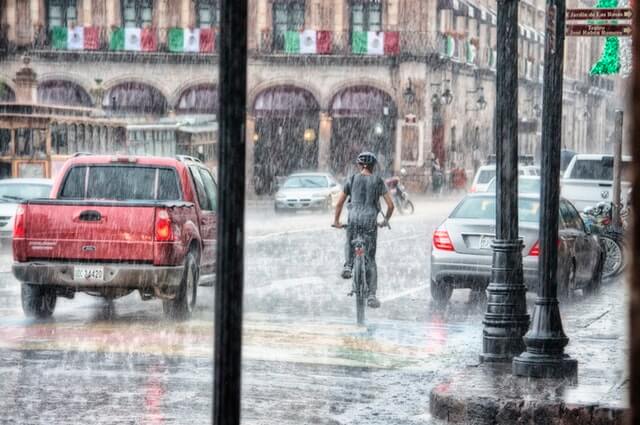 Person riding bike in the rain