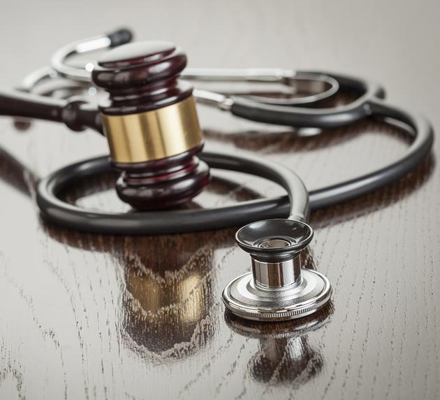 Stethoscope and Gavel on Wood Table